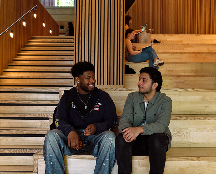 Students sitting in conversation at the Faculty of Arts building. 